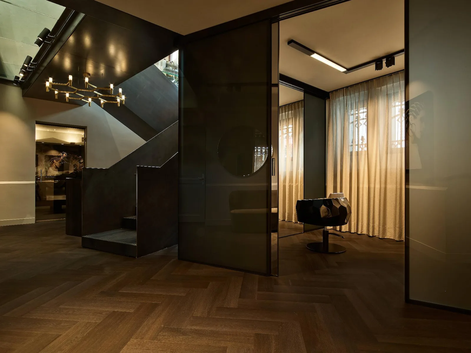 Hair Suite Conservatorium Hotel met Rimadesio glaswand, geïntegreerde verlichting en maatwerk interieur in warme, ingetogen materialisatie.