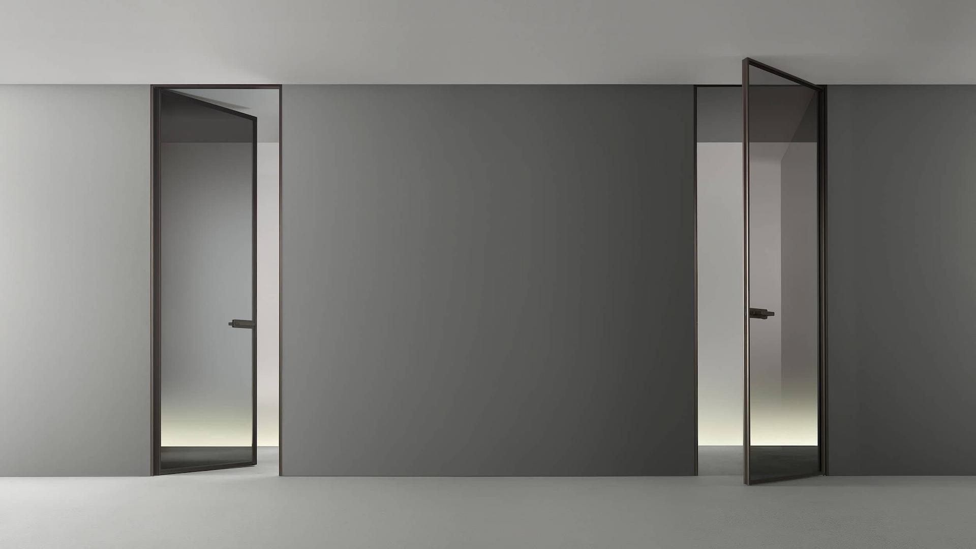 Rimadesio Zen taatsdeur met slank aluminium profiel en glas toegepast als transparante scheiding in een minimalistisch interieur